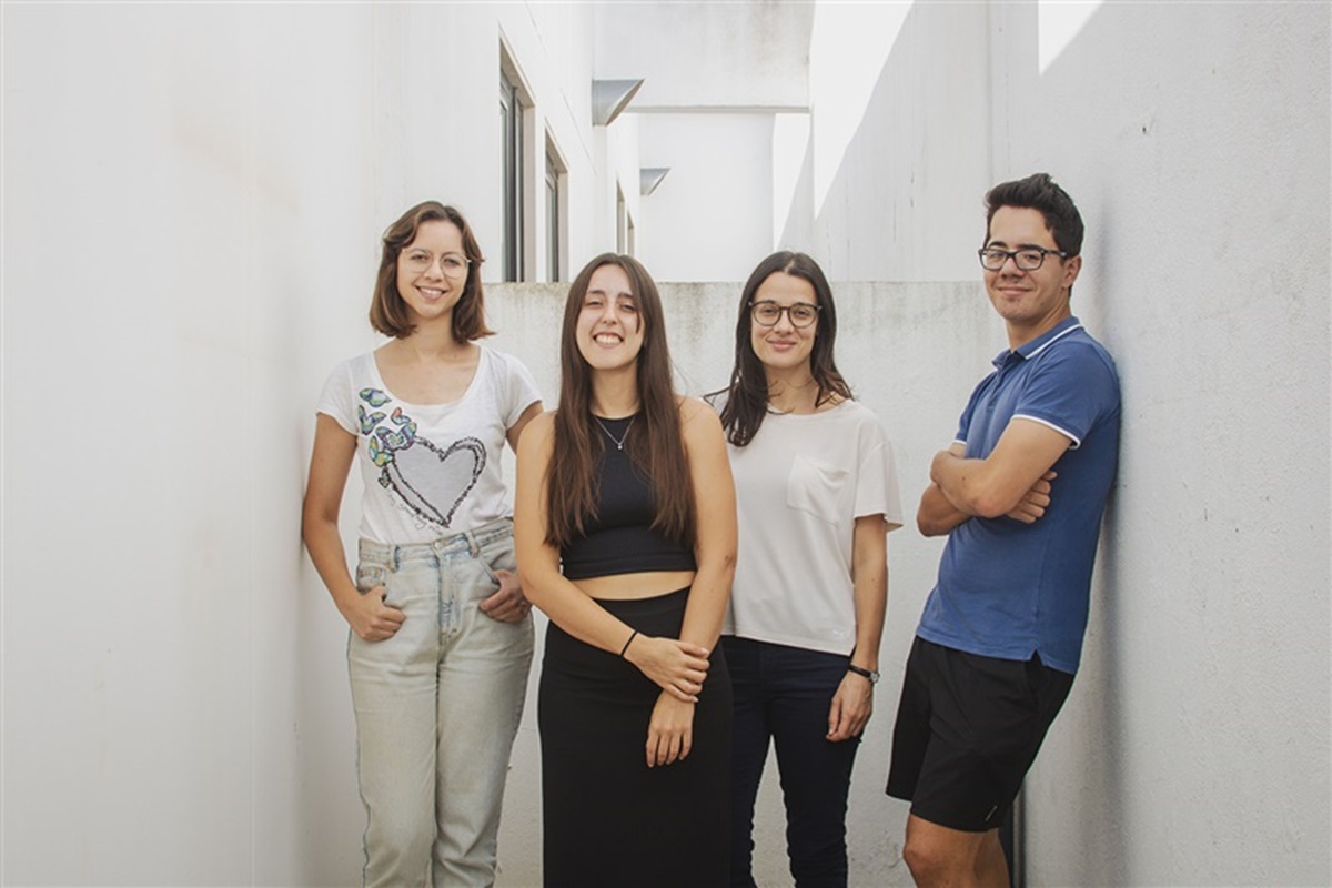 Four young journalists, smiling.